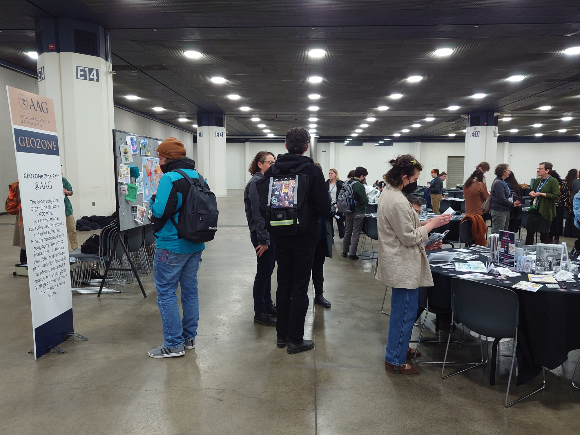 People chat and explore zines at the zine fair.